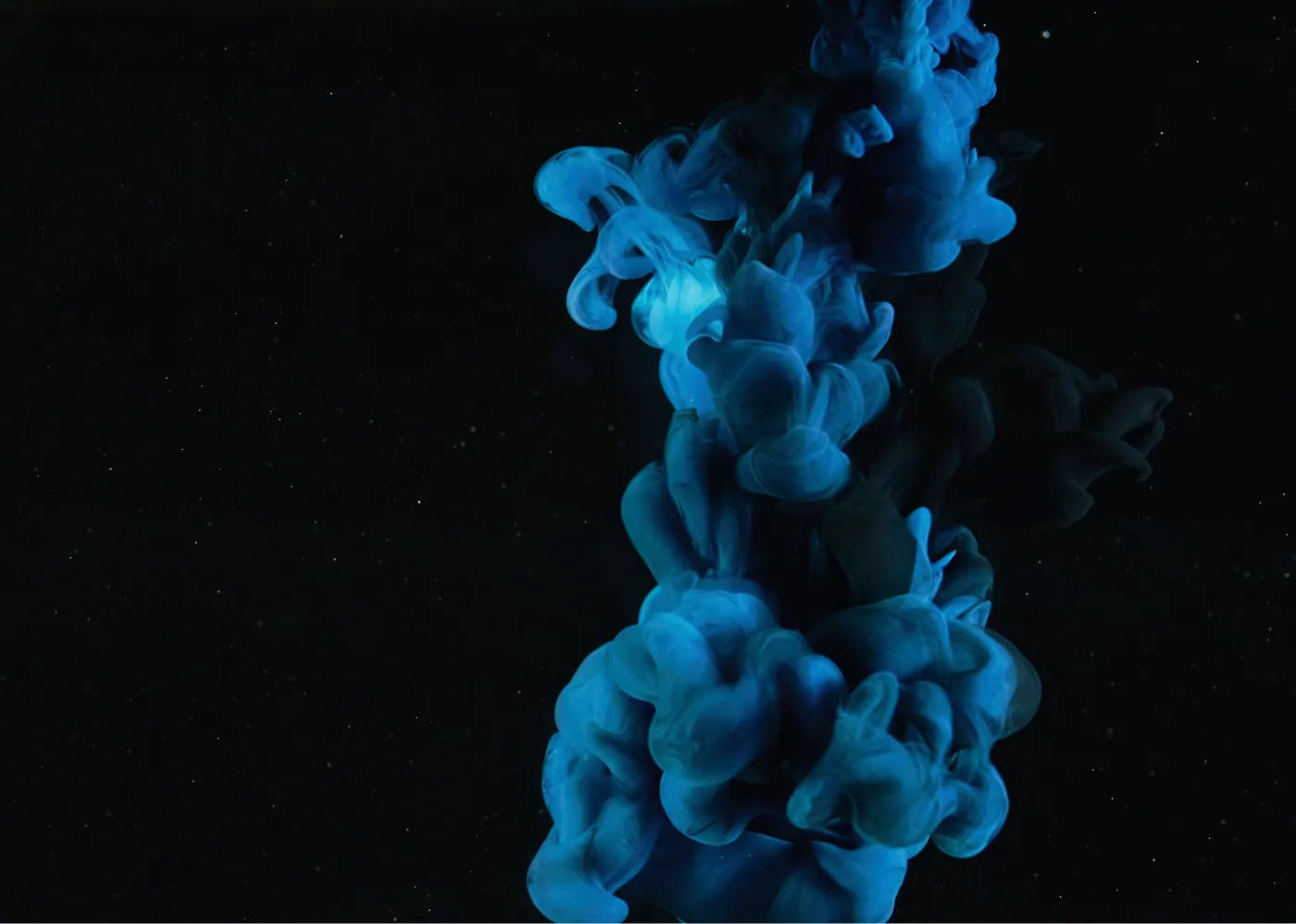 Blue ink smoke on black background